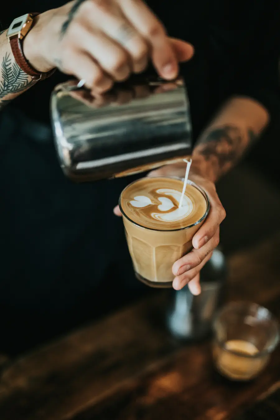 Barista preparing coffee behind the bar at Café Jolie